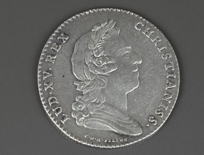 gros plan d'une pièce de monnaie sur laquelle figure une tête de femme
