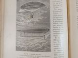 an open book with a picture of a hot air balloon in the sky