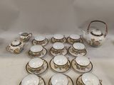a lot of cups and saucers on the table
