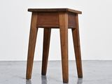 a small wooden table with a drawer on top of it