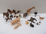a lot of toy animals that are on a table