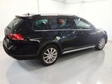 a black volkswagen golf wagon parked in a garage