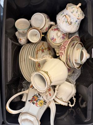 a black container filled with many different types of tea cups and saucers