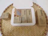 three boxes of lip bales on a tray on a table