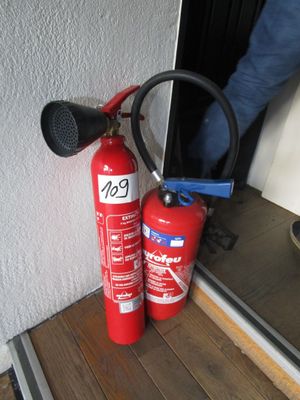 a fire extinguisor and a hose on the floor
