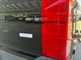a red tail light on the back of a black van