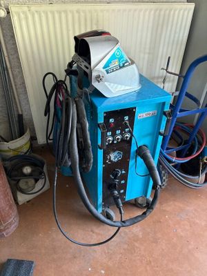 a blue machine that is sitting in a garage