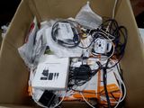 a cardboard box filled with electronic equipment and wires