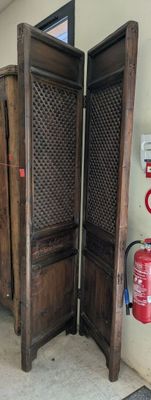 two wooden doors that are open in a room
