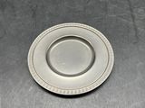a silver plate sitting on top of a metal sink