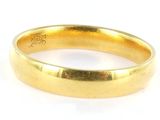 a close up of a gold ring on a white surface