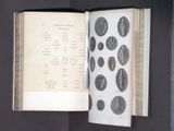 an open book with a picture of coins on it