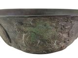 a metal bowl that is sitting on a white surface
