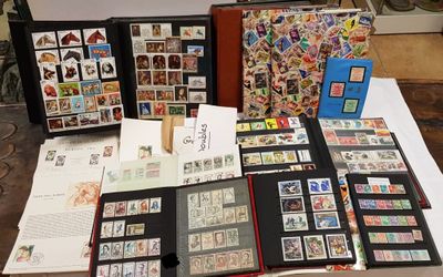 a lot of stamps on a table with a book on it