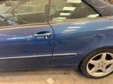 a blue car that is parked in a parking lot