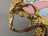 a gold plate with a picture of a man and a woman on it