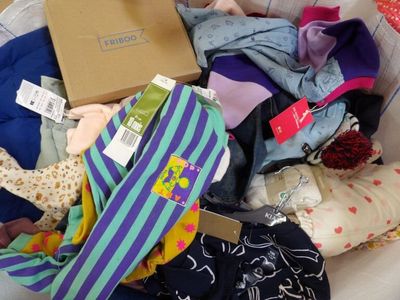 a basket full of clothes that is sitting on the floor
