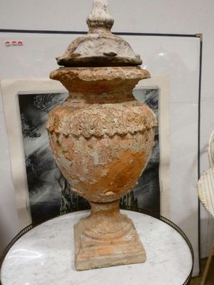 un vase posé sur une table à côté d'une chaise dans une pièce