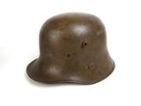 an old helmet is sitting on top of a white surface