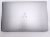 dell laptop computer sitting on top of a white table with a logo on the screen
