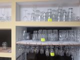 many empty glasses on the shelves in the kitchen