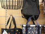 many bags hanging on the wall in a store
