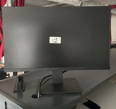 a computer monitor sitting on top of a desk