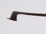 someone is holding a pair of glasses with a wooden handle