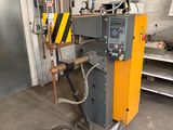 a machine that is sitting in a garage with a hose
