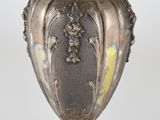 un vase en argent posé sur une table