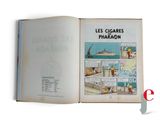 an open book with a picture of a ship in the background