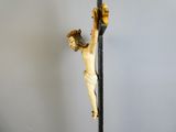 a statue of jesus on the cross with a cross behind it