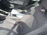 the interior of a car with black seats and a steering wheel