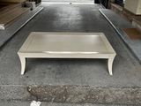 a white coffee table sitting in the middle of a parking lot