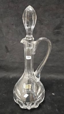 a clear glass decanter on a black background