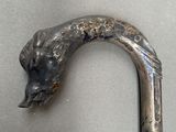 a close up of a walking stick with a bear head on it