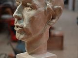a sculpture of a man ' s head on display in a museum