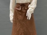an image of a mannequin wearing a white blouse and brown skirt
