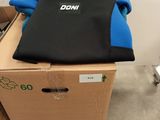 a cardboard box with a black and blue wetsuit on top of it