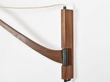 the bow is attached to the wall with a cord
