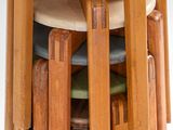 several wooden stools stacked on top of each other on a white surface
