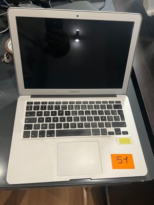 an open laptop computer sitting on top of a desk next to a keyboard