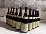 several bottles of wine are lined up in a row on a table