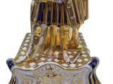 gold statue of a man in armor holding a sword and shield