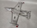 a silver model of a plane on a white surface