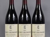 three bottles of wine sitting on top of a table next to each other
