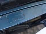a close up of a car ' s engine with a number plate on it