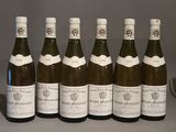 six bottles of wine are lined up in a row on a table