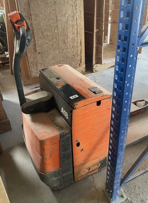 a fork lift truck that is parked in a warehouse