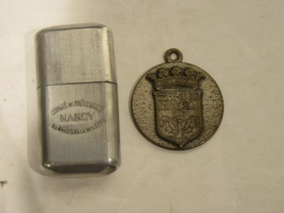 a lighter and a coin sitting next to each other